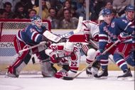 John Vanbiesbrouck, of the New York Rangers, knocks down New Jersey Devils forward, Claude Lemieux, during their game with the New Jersey Devils in East Rutherford, New Jersey, United States on January 4, 1991 - Source: Getty