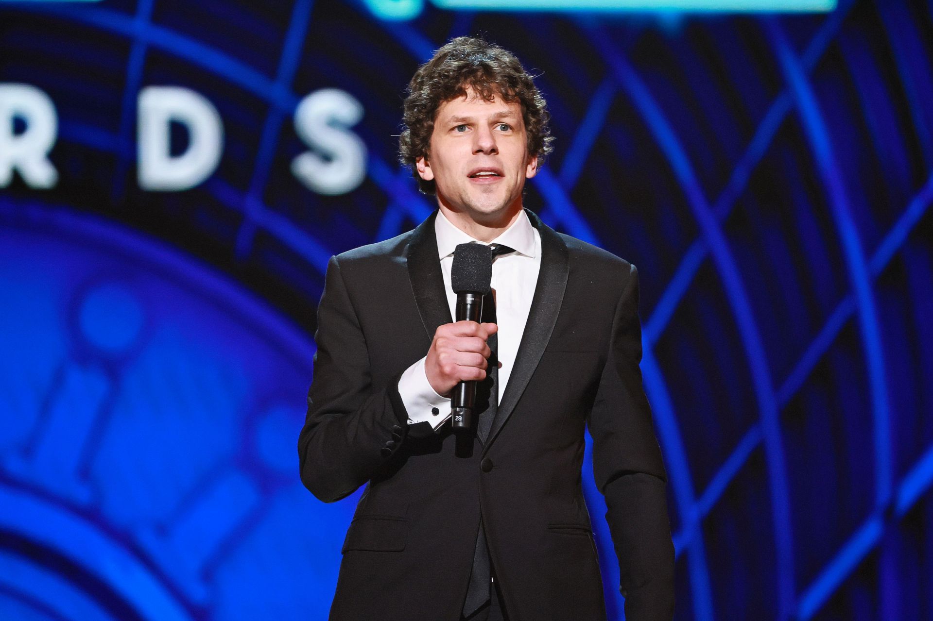 Jesse Eisenberg explains why he believes staying in the U.S. is the right choice despite criticism of Trump