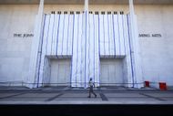 Workers walk past the John F. Kennedy Memorial Center for the Performing Arts on September 16, 2026 in Washington, DC. The new fencing composed of “bike rack” and barricade material was installed a day after the Kennedy Center Board voted to close the venue for repairs - Source: Getty