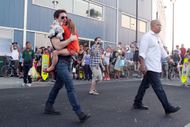 Tom Cruise gives his daughter Suri Cruise a lift on their way out of a building in NYC on July 17, 2012 - Source: Getty