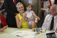 Sharon Stone holds a baby as she meets with Israeli and Palestinian children during a visit in a classroom at the children's ward at the Hadassah hospital on June 18, 2013 in Jerusalem, Israel - Source: Getty